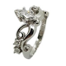 Detailed platinum and diamond engagement ring set with Marquise cut centre diamond and small brilliant cut diamonds
