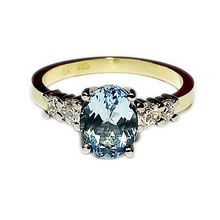 18ct yellow gold and platinum engagement ring set with oval aquamarine and brilliant cut diamonds