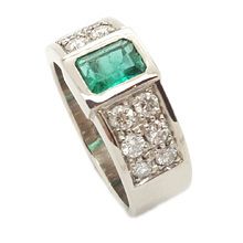9ct white gold ring, weight  = 8, 5g, set with centre emerald cut emerald 0, 71ct, and 12 × diamonds  = 0, 68ct.