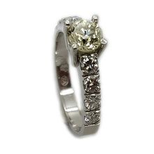 Brilliant platinum engagement ring set with centre diamond weighing 0,57ct and eight smaller diamonds weighing 0,53ct in total