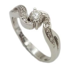 Beautiful platinim ring set with centre diamond weighing 0, 25ct and small diamonds featured in the flowing band